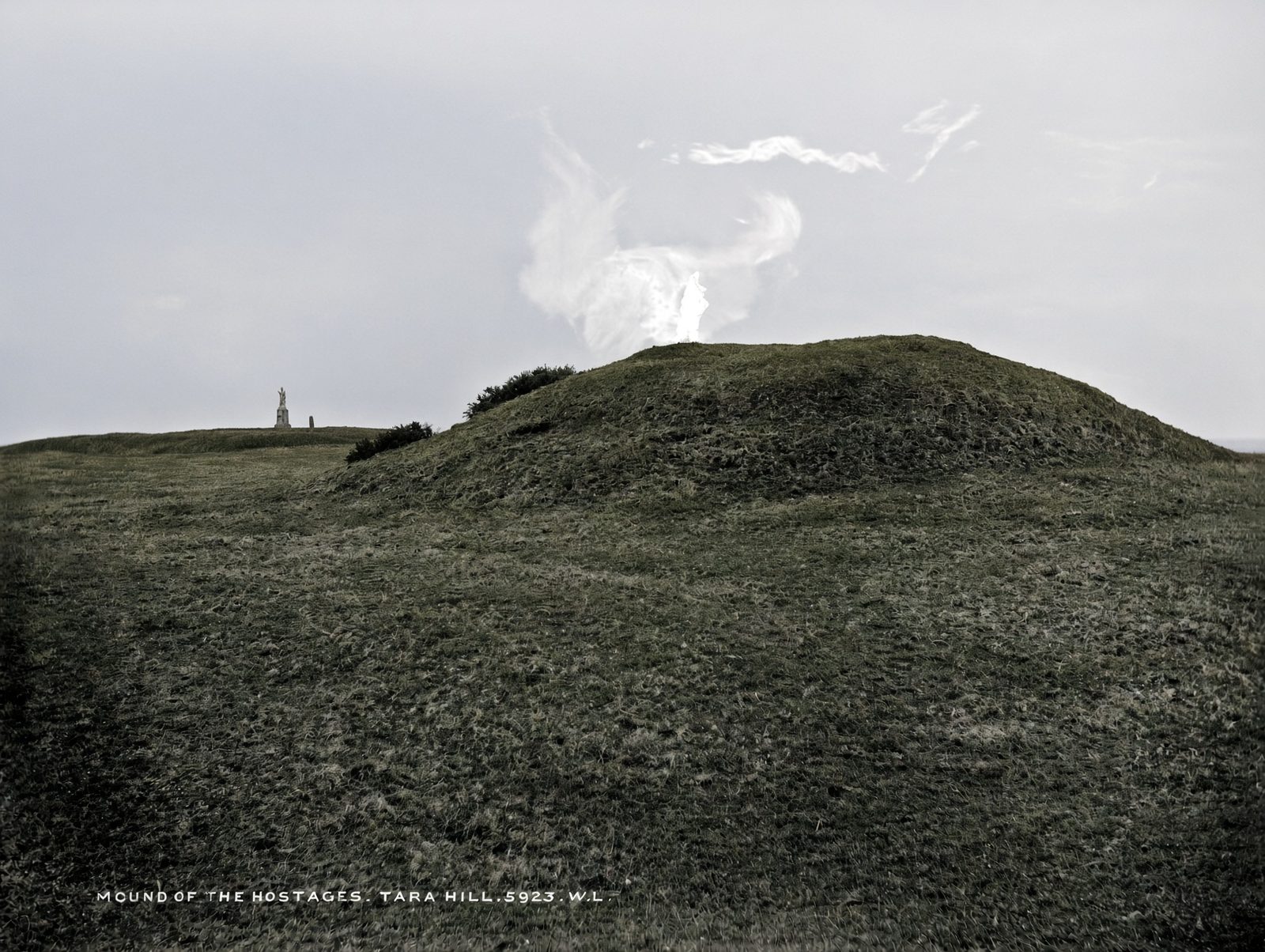 The Mound of the Hostages on the Hill of Tara, a low grassy mound under a grey sky.