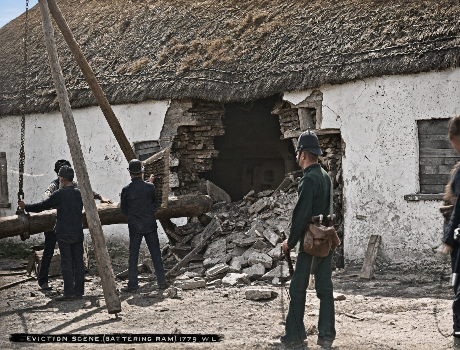 Police and bailiffs with a battering ram beside a damaged cottage on the Vandeleur estate in County Clare.